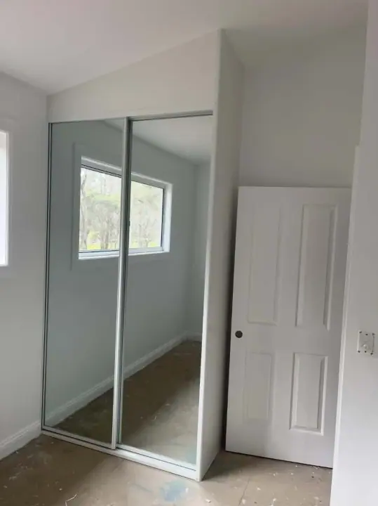 Mirrored sliding doors fitted in a room before the floor coverings