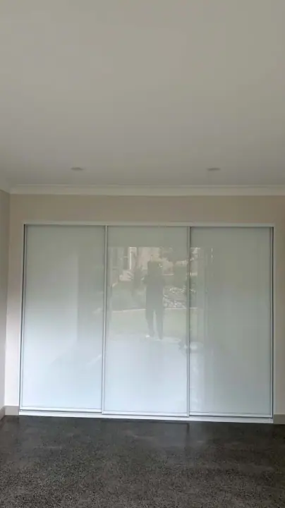White glass sliding garage cupboards, floor to ceiling