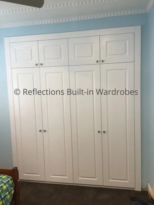 Four-door hinged wardrobe with raised panel doors
