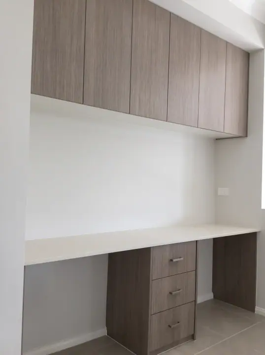 Home office with desk, drawers and overhead cupboards