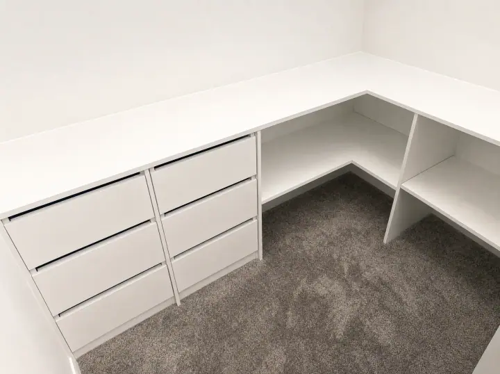 L-shaped desk with drawer units in a carpeted study