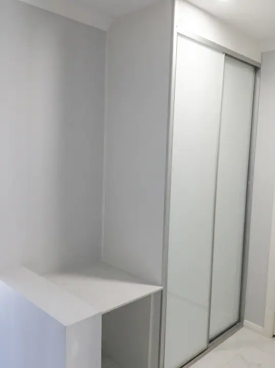 White glass sliding doors beside a built-in bench