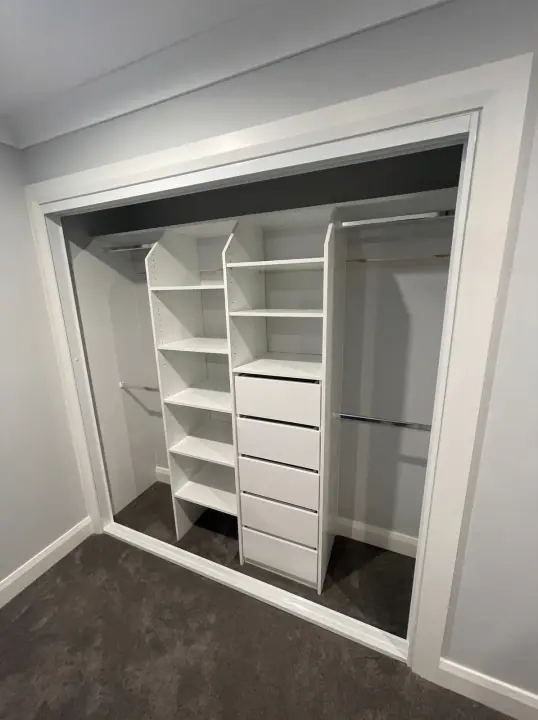 Built-in wardrobe internals fitted into a bedroom alcove