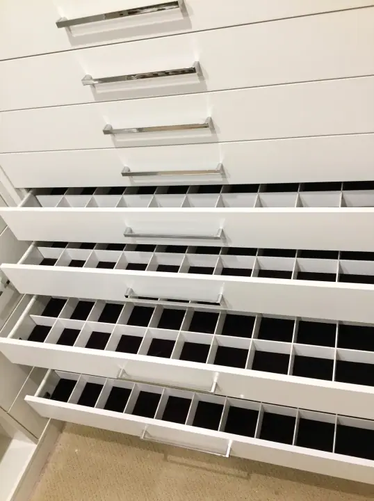 Pull-out shoe shelves inside a wardrobe