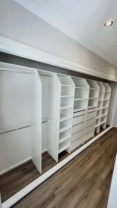 Wall-to-wall wardrobe internals with double hanging and shelving