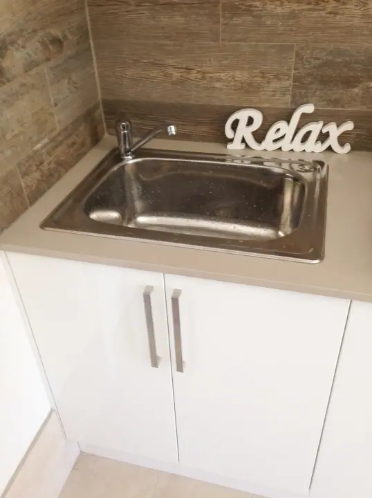Laundry sink cabinet with a stainless tub