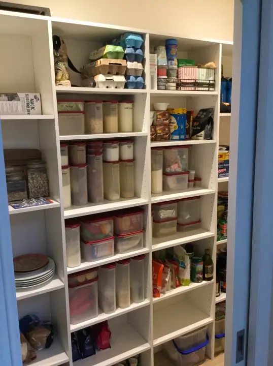 Stocked pantry shelving in a corner layout