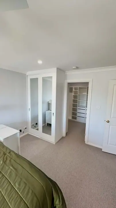 Polyurethane mirror-insert sliding doors beside a fitted walk-in