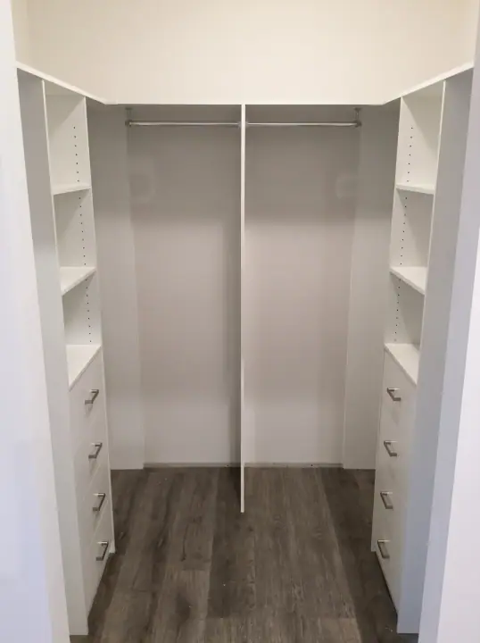 Walk-in wardrobe with full-height shelving and hanging rails