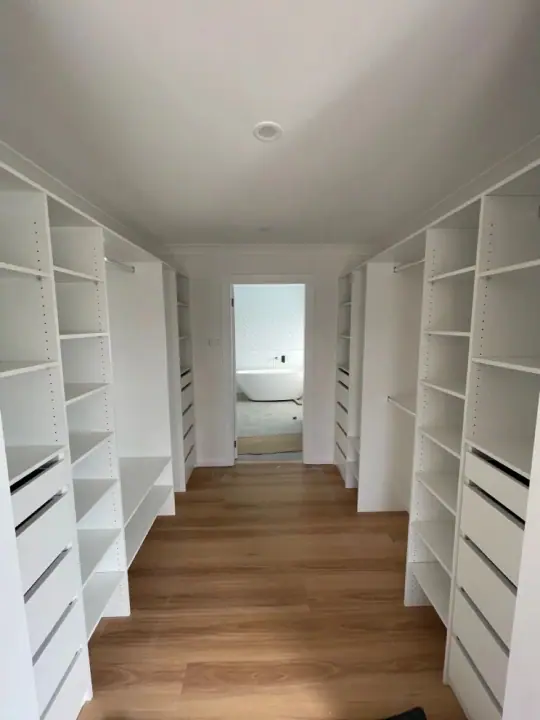Walk-in corridor with drawers and shelving on each side
