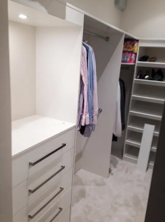 Walk-in wardrobe with drawers, hanging and hidden lighting