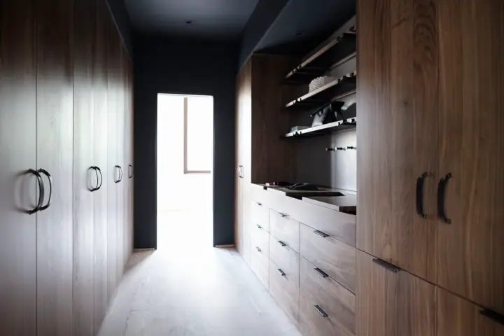 Re-fitted walk-in wardrobe with shelving and hanging