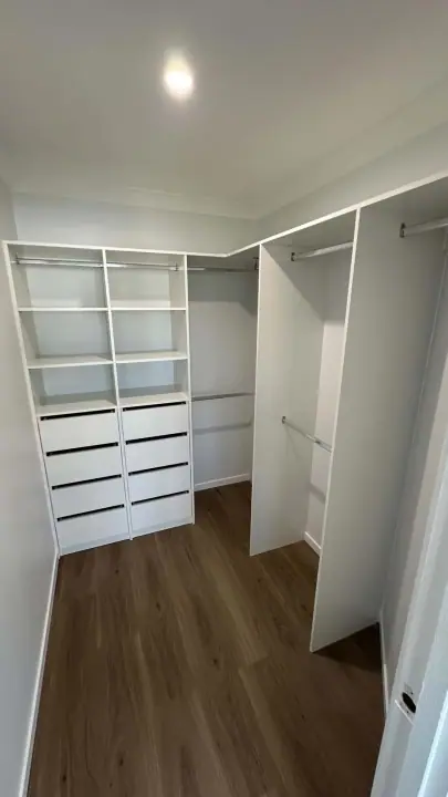 L-shaped walk-in with two drawer banks and hanging to the ceiling