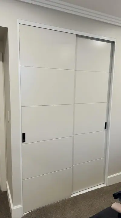 White panel sliding wardrobe doors with grooved detail