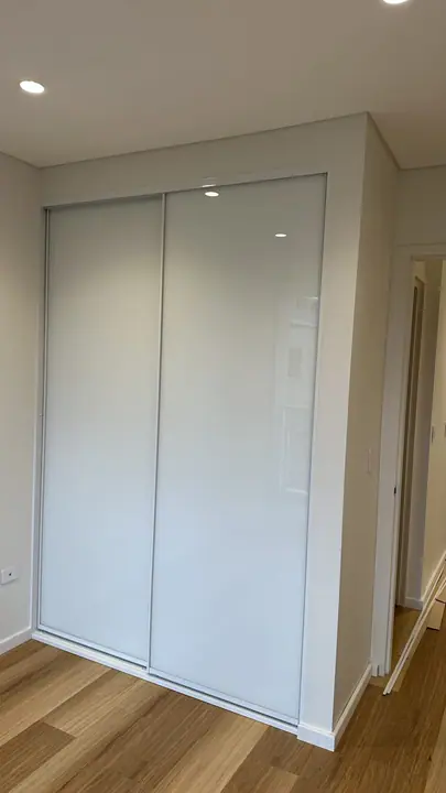 White glass sliding wardrobe doors floor to ceiling