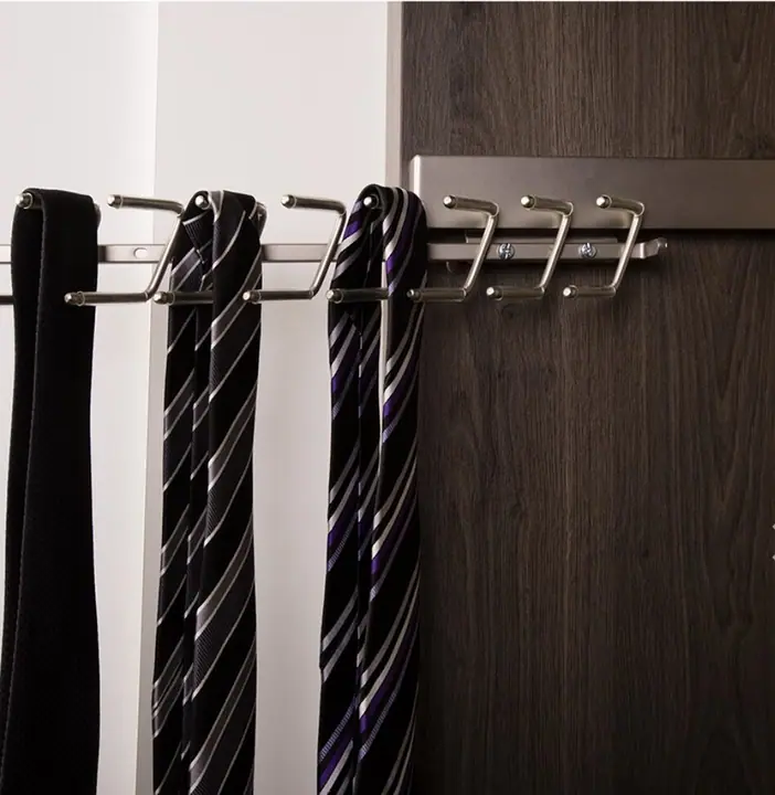 Pull-out tie rack in a dark timber wardrobe