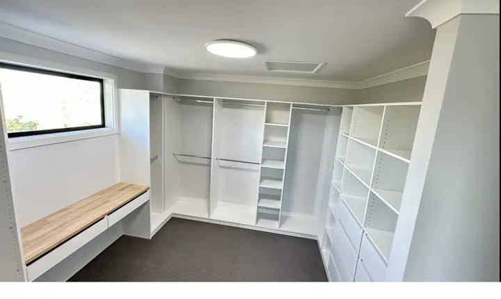 Walk-in wardrobe with a window bench seat
