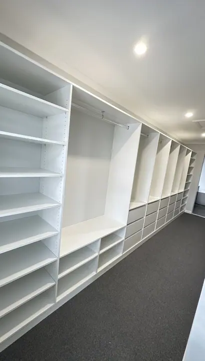 Long run of wardrobe shelving and hanging space
