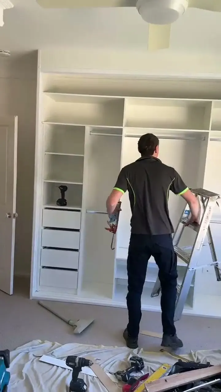 Video: installer fitting wardrobe internals on site
