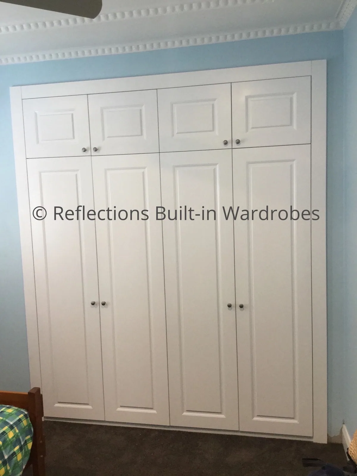 Floor-to-ceiling hinged wardrobes in a Riverstone home