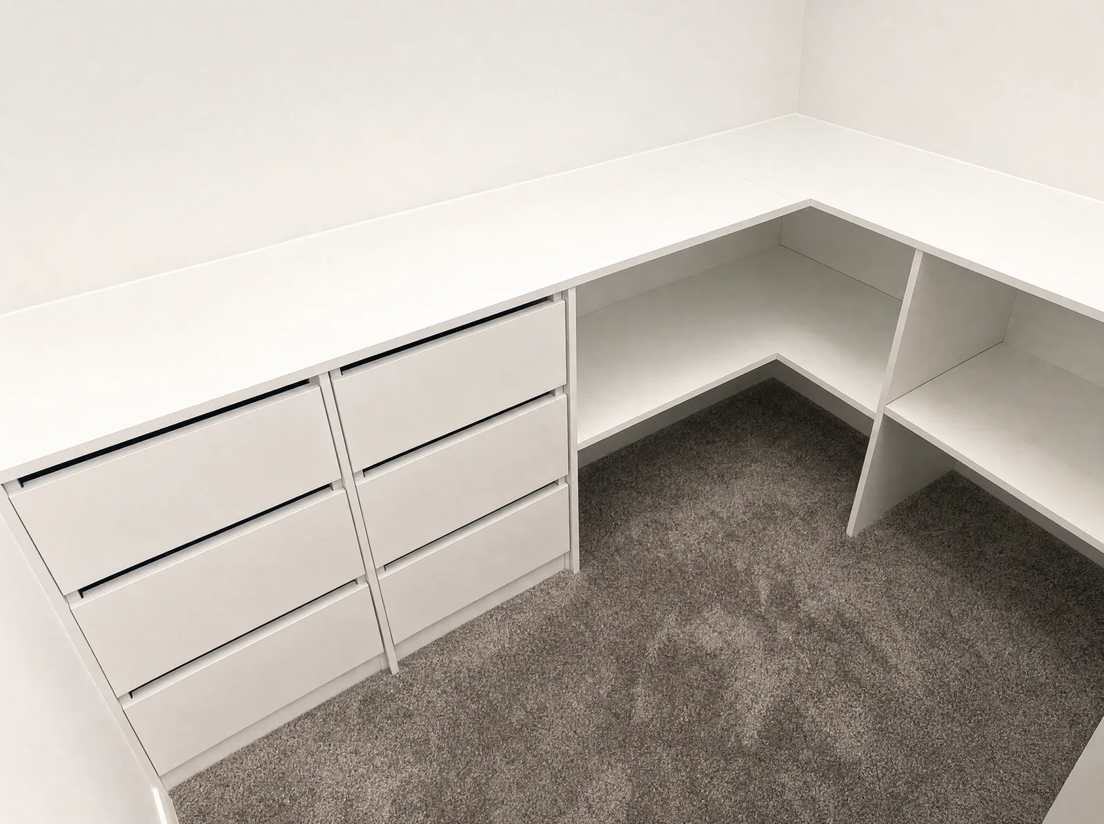 Built-in study desk with drawers and overhead cupboards in a spare bedroom