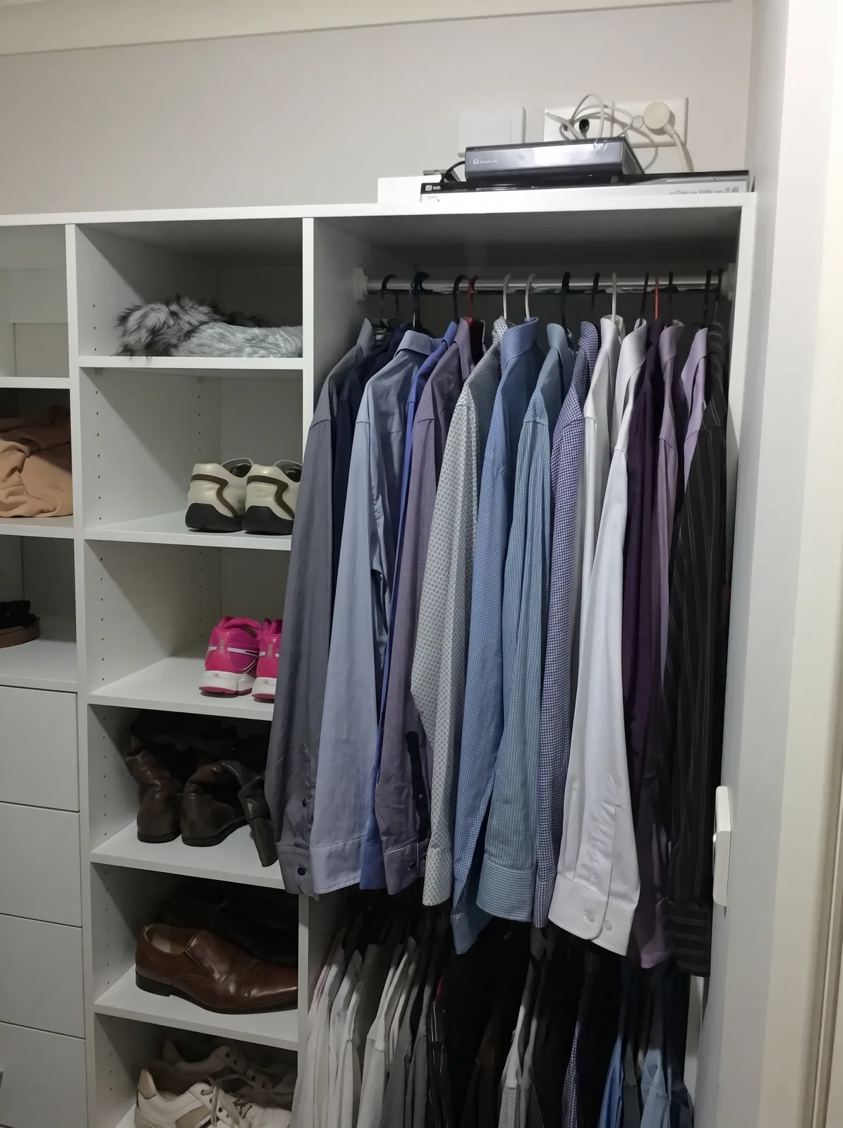 Compact walk-in wardrobe with hanging on both sides in a Glenwood home
