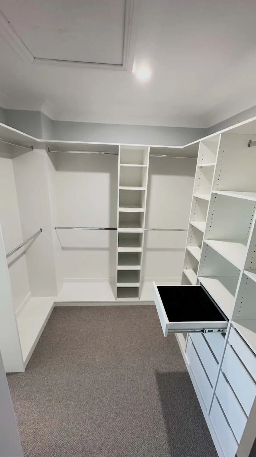 Builder walk-in wardrobe re-fitted with double hanging, shelving and drawers