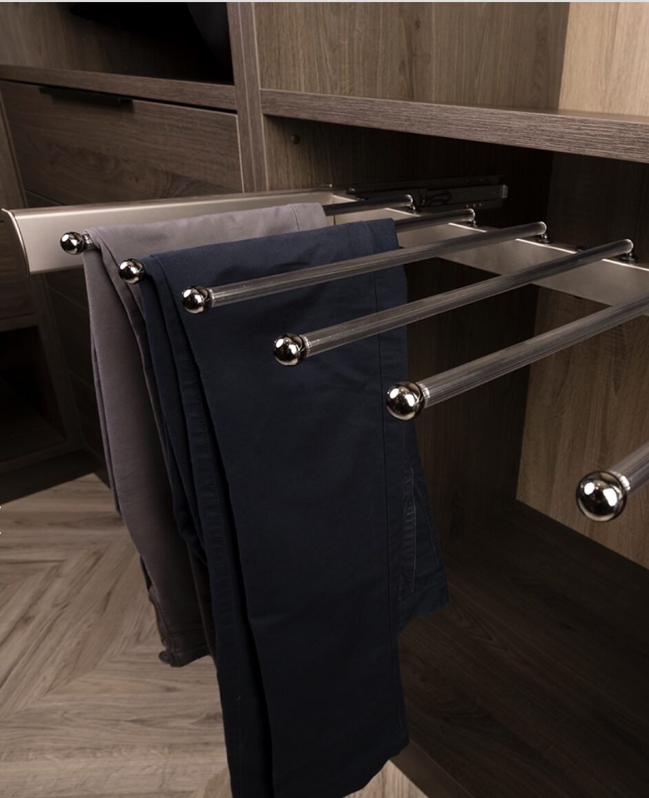 Pull-out pants rack with trousers hanging on chrome rails